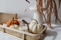 Kaboompics - White and Orange Pumpkins with a Candle in a Wicker Tray