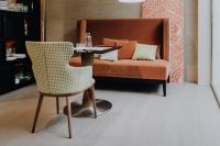 Kaboompics - Modern Lounge Interior with Patterned Armchair, Orange Sofa and Dining Table