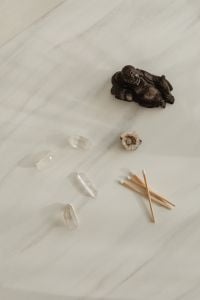 Kaboompics - Meditation Flatlay With Buddha Statue Crystals And Wooden Matchsticks