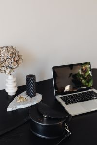 Kaboompics - Minimal Home Office with Laptop, Black Candle, Leather Bag and Dried Flowers