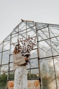 Kaboompics - A beautiful tall woman holds cotton branches