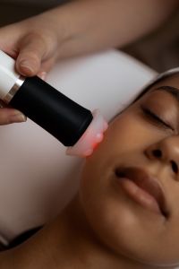 Kaboompics - Red Light Skincare Treatment on Woman's Cheek