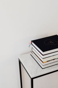 Kaboompics - Minimalist Book Stack on Marble Table with Blank White Wall