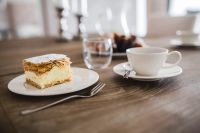 Kaboompics - Sweet dessert with cream an a cup of coffee on a table