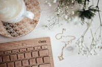 Kaboompics - Overhead Desk Styling with Coffee, Keyboard and Gold Necklace