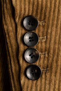 Kaboompics - Close-Up of Four Dark Buttons on a Camel Corduroy Blazer Cuff, Ribbed Tailoring Detail