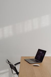 Kaboompics - Minimalist Laptop Desk With Empty Chair And Wall Copy Space