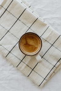 Kaboompics - Top View of Coffee Cup on a Checkered Cloth