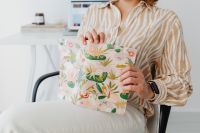 Kaboompics - Woman Holding a Floral Notebook in a Minimal Home Office