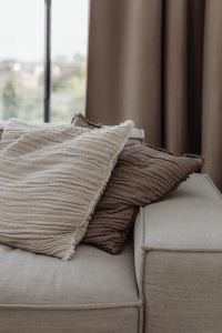Kaboompics - Close-Up of Textured Throw Pillows on a Beige Sofa