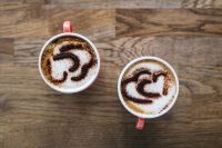 Kaboompics - A cups of coffee with heart latte art on top