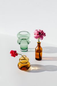 Kaboompics - Pink and Red Carnations Styled with Amber and Green Glass Vases