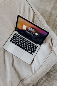 Kaboompics - Close-Up Laptop on Beige Sofa with Soft Neutral Background