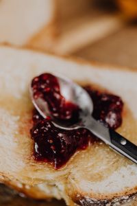 Kaboompics - Honey and Raspberry Jam Jars Framed by Challah Slices