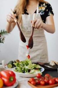 Kaboompics - Close-Up of Salad Preparation with Wooden Servers and Fresh Vegetables