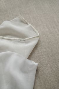Kaboompics - White Textile with Seam Detail on Beige Sofa
