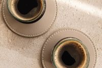 Kaboompics - Overhead Pair of Espresso Glasses on Round Taupe Coasters