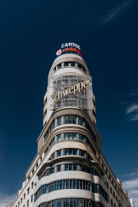 Kaboompics - Capitol Building with Schweppes and Vodafone Signs Against Deep Blue Madrid Sky