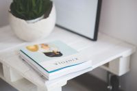 Kaboompics - Small wooden table with a potted plant and a grey wallet