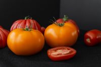 Kaboompics - Ripe Red and Orange Tomatoes on a Dark Background