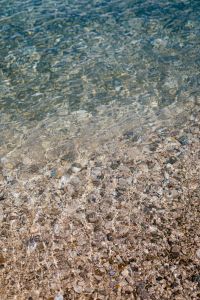 Kaboompics - Blue Coastal Water over Pebble Beach with Sunlit Ripple Pattern