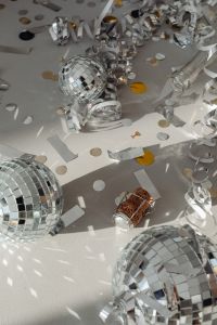 Kaboompics - Close-Up Mirror Ball with Curled Streamers and Champagne Cork on the Floor