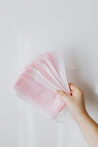 Kaboompics - Hand Holding a Fan of Pink Disposable Face Masks