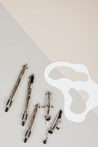 Kaboompics - Drafting Compasses with White Curved Shapes