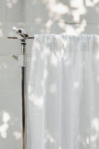 Kaboompics - Gathered Curtain on a Metal Stand in Sunlight