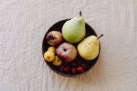 Kaboompics - Overhead Wooden Bowl of Apples, Pears, Yellow Fruit and Red Berries on Beige Linen