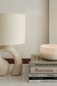 Kaboompics - Close-Up Ceramic Lamp and White Vessel on Stacked Design Books
