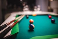 Kaboompics - Billiard balls on green table with billiard cue