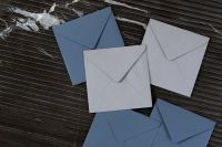 Kaboompics - Blue and White Envelopes on Dark Striped Marble, Landscape Stationery Flat Lay