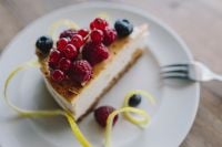 Kaboompics - Berry Cheesecake Slice on White Plate with Fresh Berries