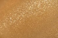 Kaboompics - Diagonal Glitter Sweep Across a Gold Background