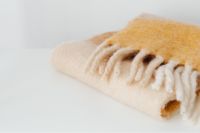 Kaboompics - Folded Cream and Tan Fringed Blanket