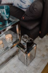 Kaboompics - Turquoise Drinking Glass beside Dark Sofa and Candle Decor on a Patterned Rug