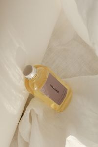 Kaboompics - Fragrance Oil Bottle Laid Diagonally on White Linen