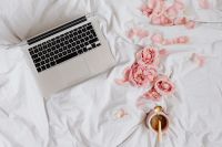 Kaboompics - Overhead Laptop, Pink Roses and Coffee on White Bedding, Romantic Valentine's Flat Lay