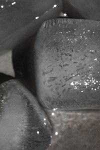 Kaboompics - Close-Up of a Textured Ice Cube in Water with Sparkling Highlights, Abstract Cold Drink Background