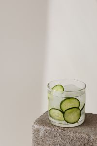 Kaboompics - Vertical Cucumber and Lime Detox Water with Ice, Glass Low in Frame and Generous Neutral Copy Space