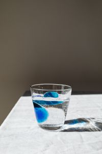 Kaboompics - Clear Water Glass with Blue Detail and Dramatic Shadow, Minimal Beverage Ad