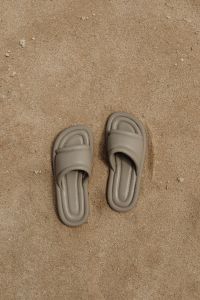 Kaboompics - Taupe Padded Slide Sandals Seen from Above on Sand