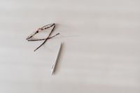 Kaboompics - Tortoiseshell Eyeglasses and Silver Pen on Beige Copy-Space Background
