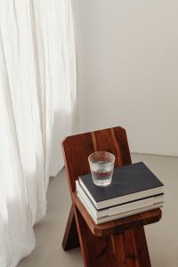 Kaboompics - Close-Up Water Glass and Books on Wooden Folding Stool