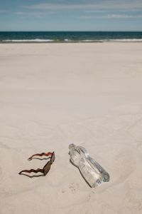 Kaboompics - Sunglasses and Clear Water Bottle on the Beach