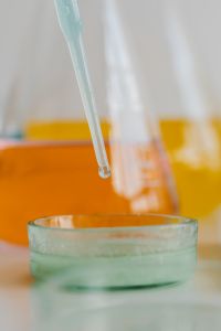 Kaboompics - Close-Up of Laboratory Dropper With Orange Glassware