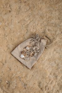Kaboompics - Mixed Gold and Silver Jewelry in a Linen Drawstring Pouch