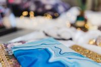 Kaboompics - Blue Patterned Planner Cover and Gold Glitter Smartphone on White Bedding, Close-Up