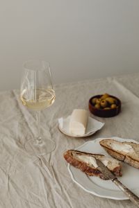Kaboompics - Butter, Olives, and Wine on a Linen Table